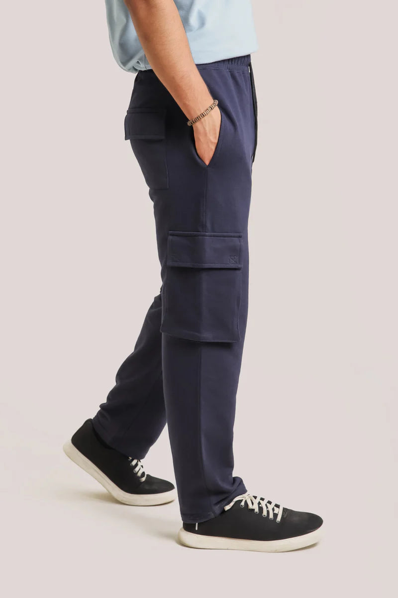 Side view of a man wearing navy cargo pants from ZANE, showcasing their practical pockets and relaxed fit, ideal for upgrading summer 2024 fashion in Pakistan.